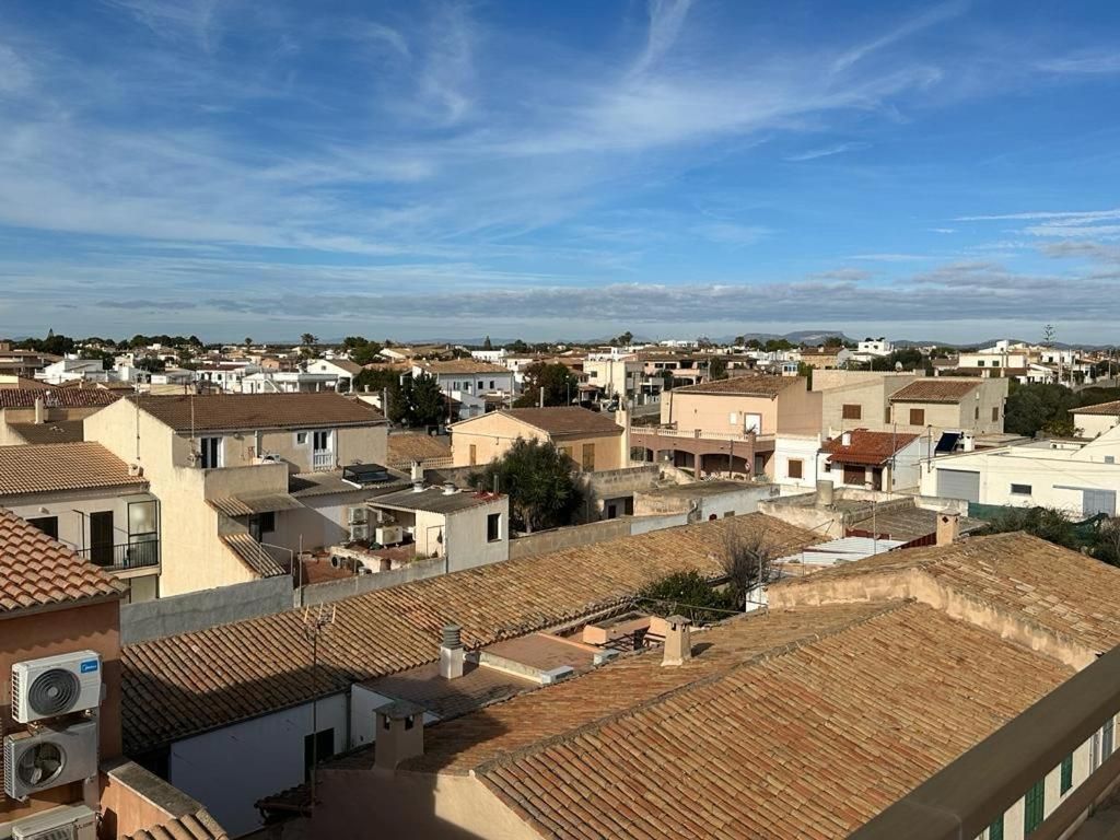 A residential area with multiple buildings, some with flat roofs and others with sloped roofs.