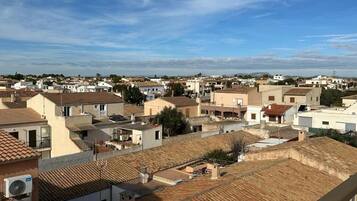 A residential area with multiple buildings, some with flat roofs and others with sloped roofs.
