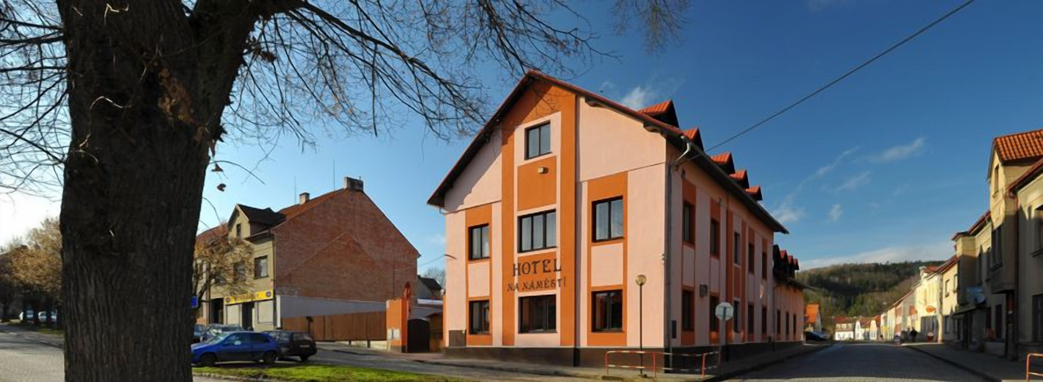 A two-story building with a sign reading 'HOTEL NAAMESTI.'