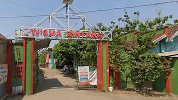 A gated entrance with a sign reading 'VISMA BINTANG' and a solar panel above.