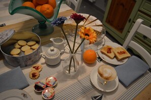 A table set with a variety of food items, including cookies, a pie, and a cup of coffee. - B B Al Golfo (Salerno)