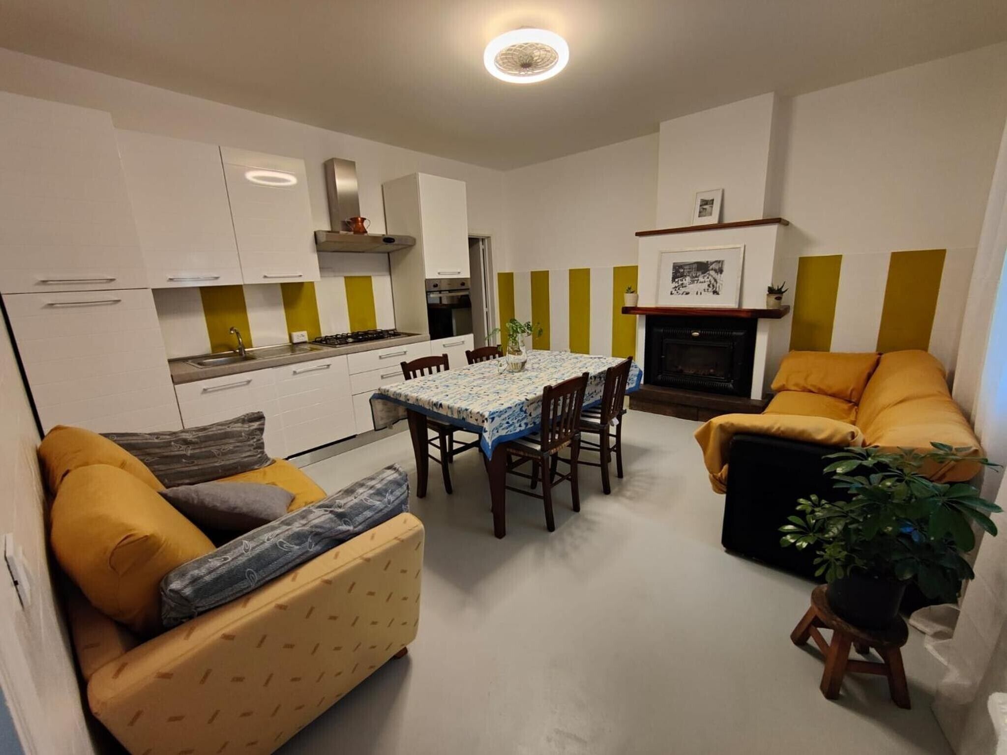 A compact living space with a kitchen, dining area, and seating arrangement.