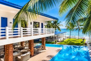 A resort with a pool, outdoor seating, and a view of the ocean. - Brizo Beach Resort Bataan (Morong)