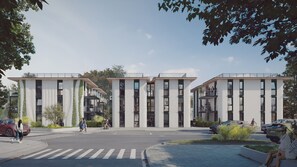 A modern building with a flat roof, large windows, and a pedestrian crossing.