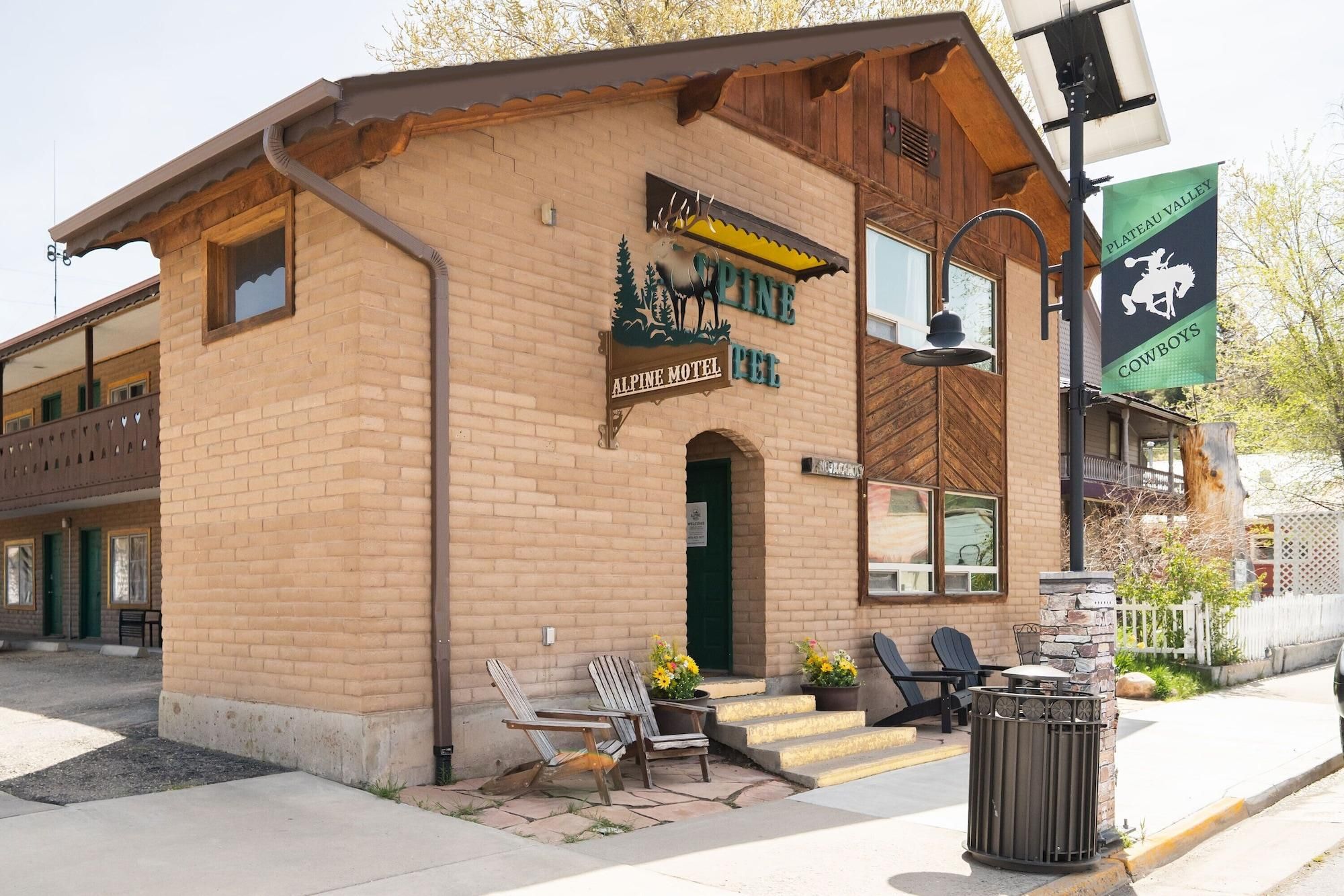 A brick building with a sign for the Alpine Motel.