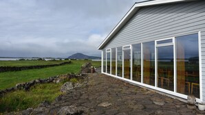 A building with large windows and a stone pathway leading to it.