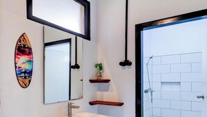 A bathroom with a white sink, a mirror, a shower, and a toilet. - Collection O At Jalan Padma Legian Beach (Legian)