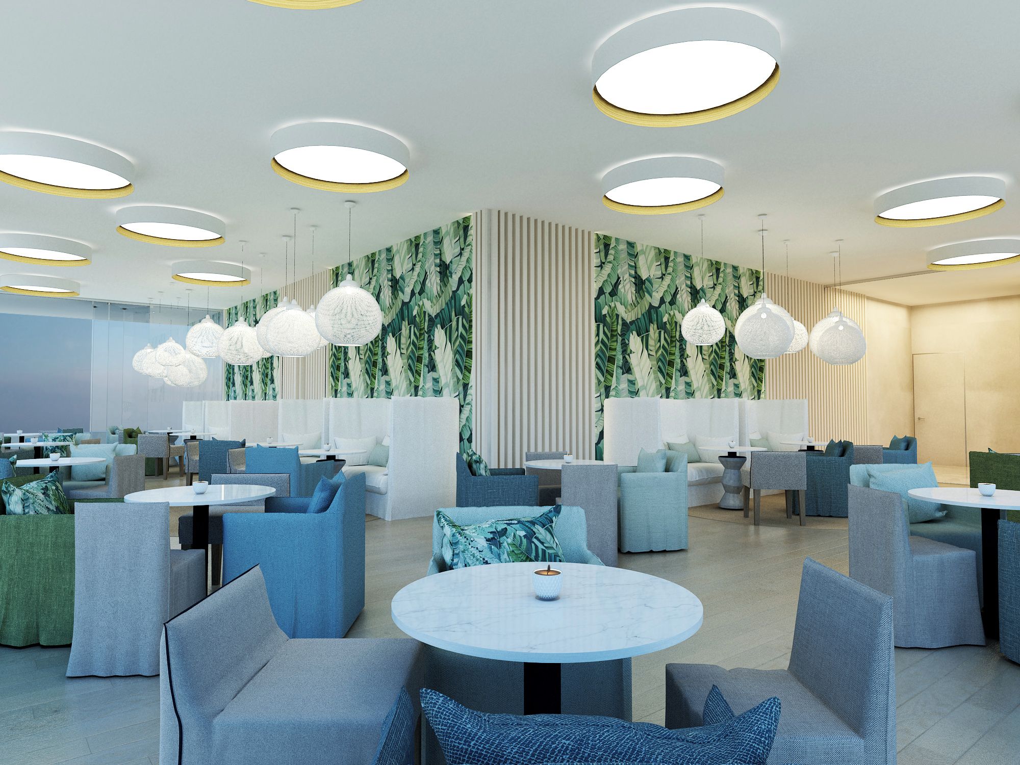 A modern restaurant with round tables, blue and grey seating, and a tropical leaf-patterned wall.