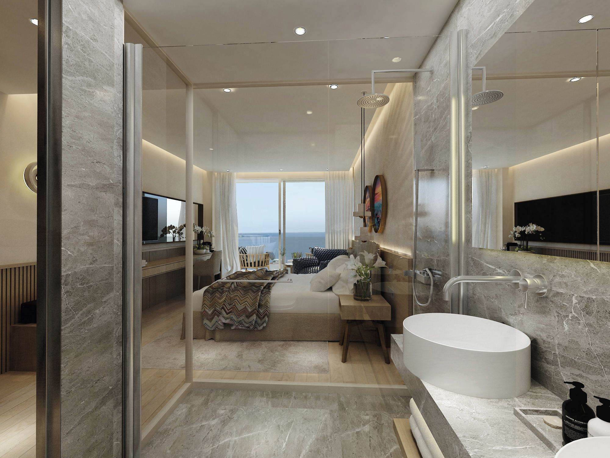 Un baño moderno con una bañera grande, ducha con mampara de vidrio y vistas al mar.