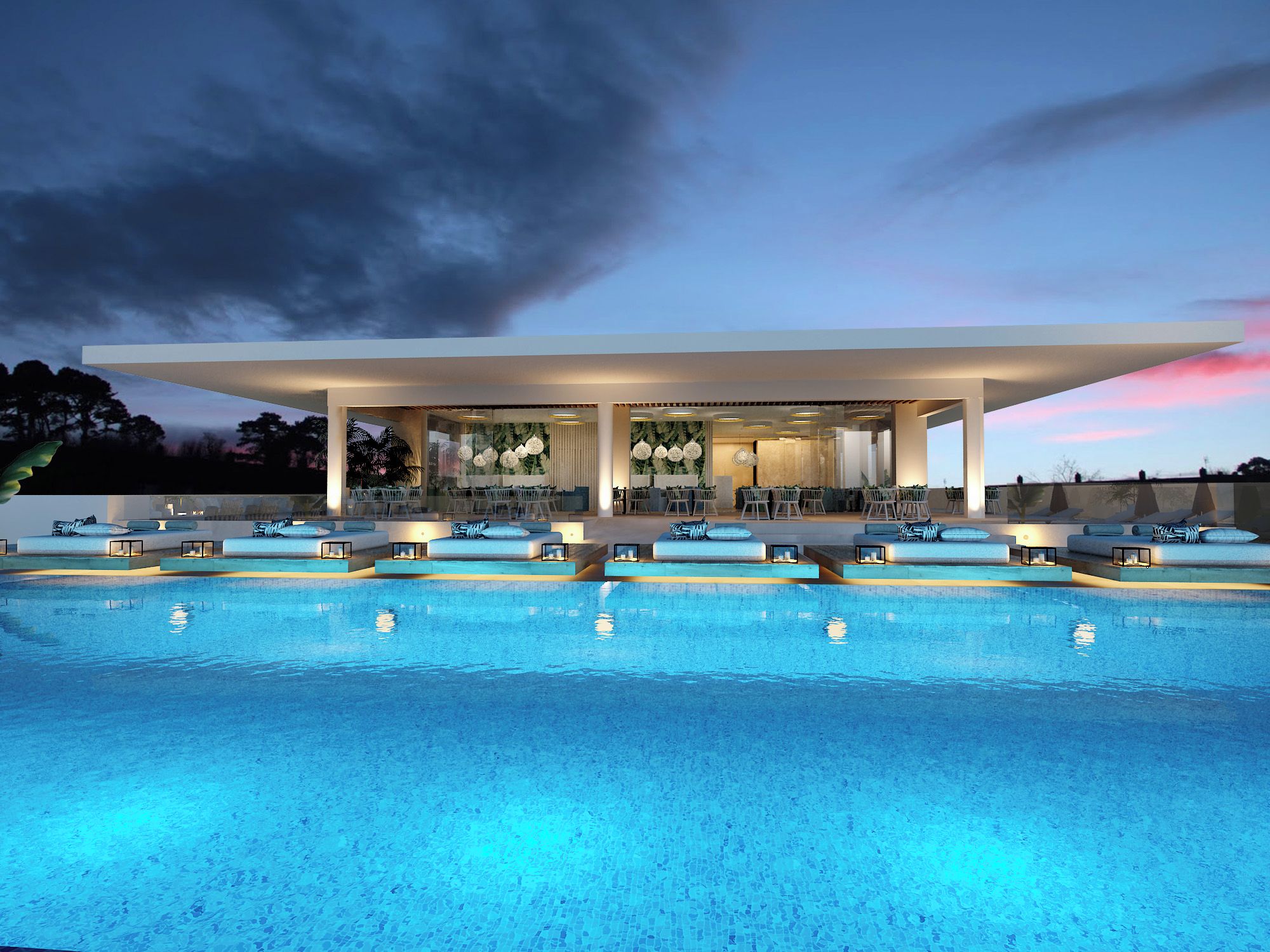A modern hotel with a pool area, outdoor seating, and a covered lounge.