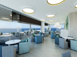A modern outdoor seating area with round tables and chairs, large windows, and a view of the sea. - Infinity Napa Hotel (Ayia Napa)