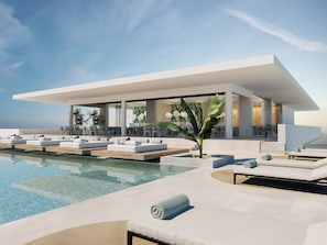 A modern hotel with a pool, sun loungers, and a covered outdoor area. - Infinity Napa Hotel (Ayia Napa)