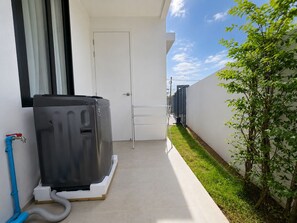 A narrow outdoor corridor with a large appliance, a metal ladder, and a hose. - Villa Luna 2BR Private Plunge Pool (Si Sunthon)