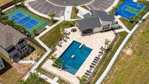 An aerial view of a residential area with a swimming pool, tennis courts, and a modern house. - The House Mcallen 3bdroom Pool (McAllen)