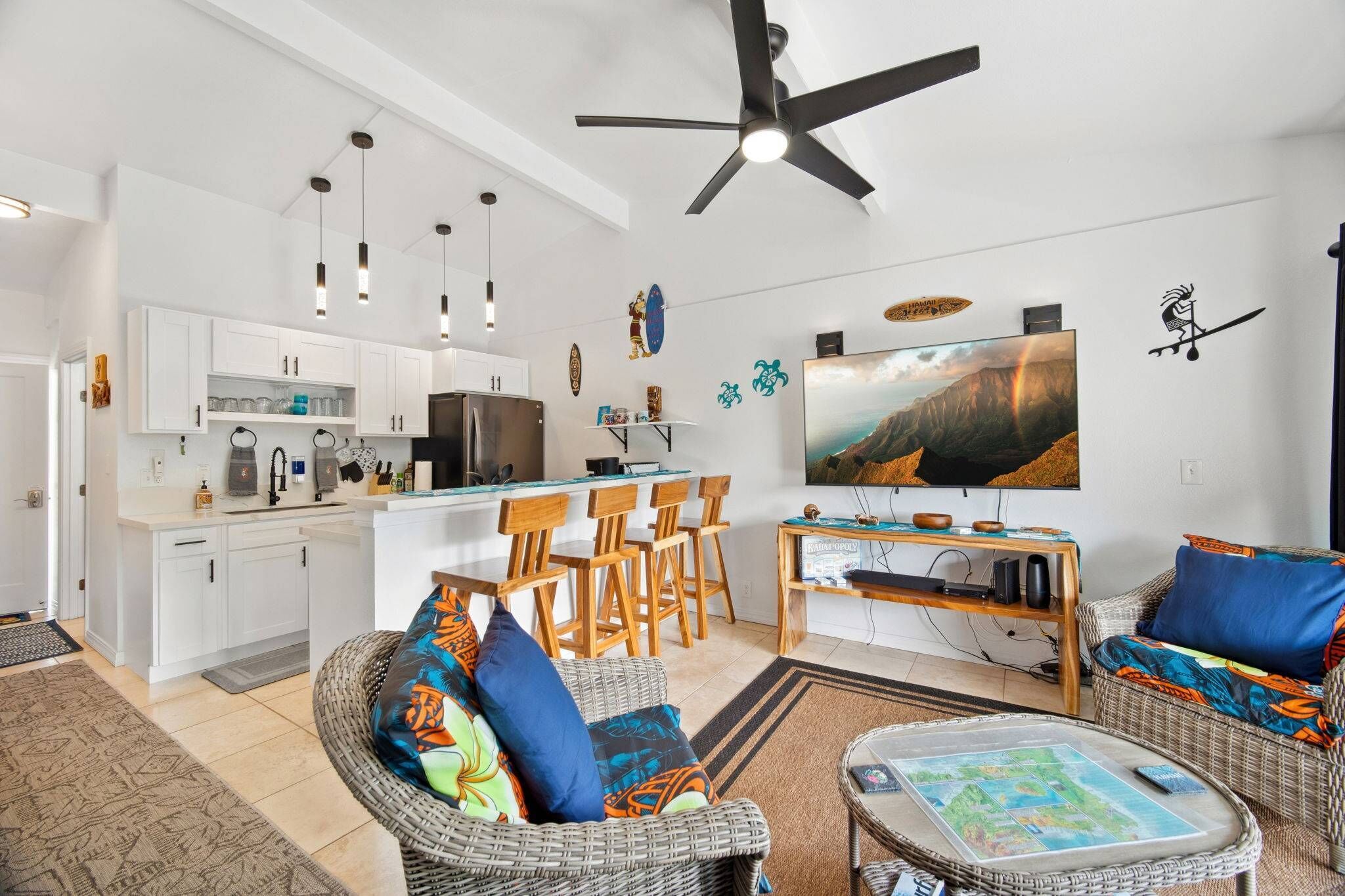 A modern living space with a kitchen, dining area, and seating.