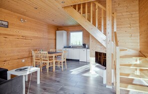 A wooden interior with a dining area, kitchen, and staircase. - Awesome home in Dobieslawiec with sauna (Dobieslawiec)