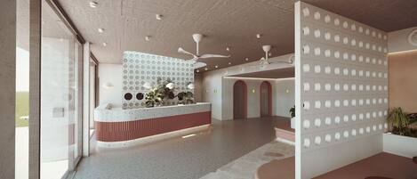 Un área de recepción moderna con un mostrador central, ventiladores de techo y un muro con diseño.