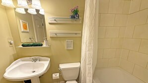 A bathroom with a sink, toilet, and bathtub. - Oceanfront Suite with Relaxing Tub & Private Bath - Rm 2 (Gabriola)