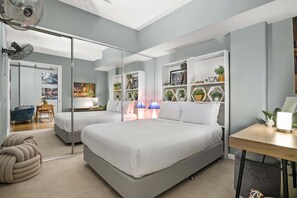 A modern bedroom with a large bed, a desk, and a mirror. - Temple Court Suite in Melbourne CBD (Melbourne)