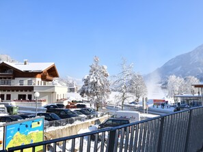 A snowy mountain town with a hotel, parked cars, and a clear sky. - Luxury apartment with spa next to the gondola (Brixen im Thale)