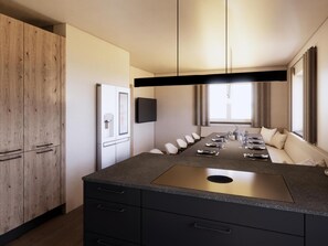 A modern kitchen with a central island, built-in appliances, and a dining area with a sofa. - Modern apartment for 16 people near the gondolas (Kirchberg in Tirol)