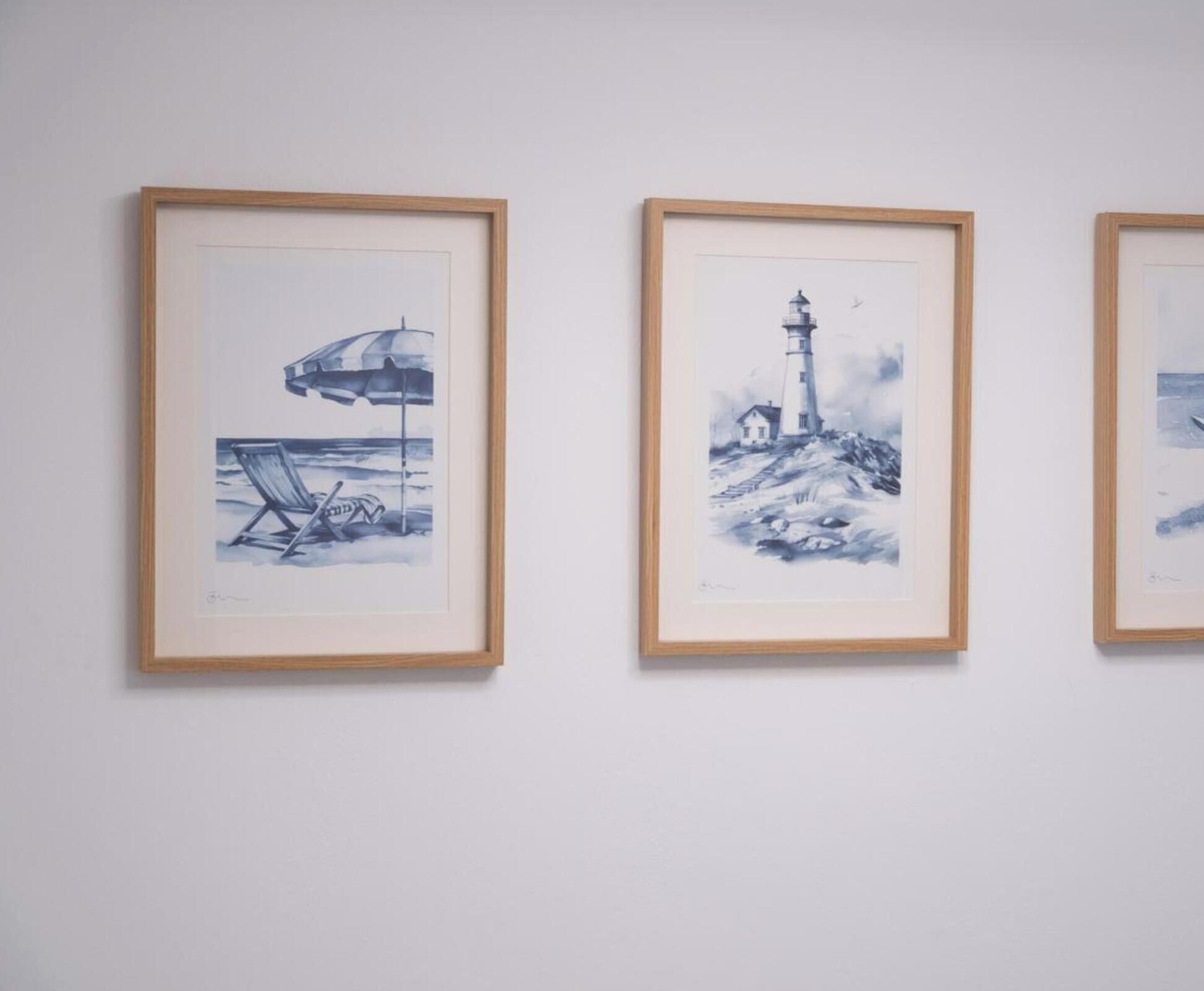 Three framed artworks on a wall.