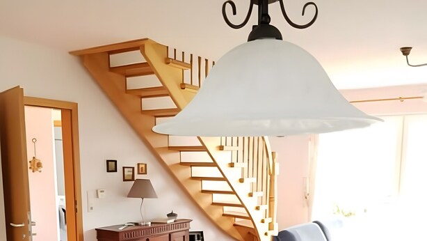 A modern interior with a staircase, dining area, and a sofa. - Holiday Home 'House Kiki in Dornumersiel' with Private Terrace, Private Garden and Wi-Fi (Dornum)