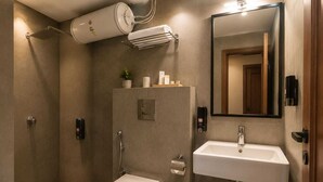 A modern bathroom with a toilet, sink, and shower. - HOTEL MUDITA BY KIRTI (Patna)