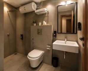 A modern bathroom with a toilet, sink, and shower. - HOTEL MUDITA BY KIRTI (Patna)