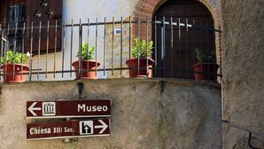 A stone building with a sign indicating a museum and a church.