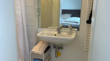 Shower, hair dryer, towels, toilet paper