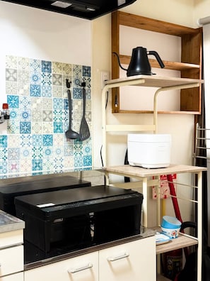 A kitchen with a tiled backsplash, a coffee maker on a shelf, a printer on a counter, and a fire extinguisher. - (千本南)Doraemon House in Osaka | 4 Min to Subway | Tea Room | Easy Airport Access (Osaka)