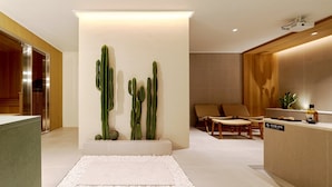 A modern interior with a reception desk, seating area, and cacti wall art. - Anook Hotel Busan Gwangalli (Busan)