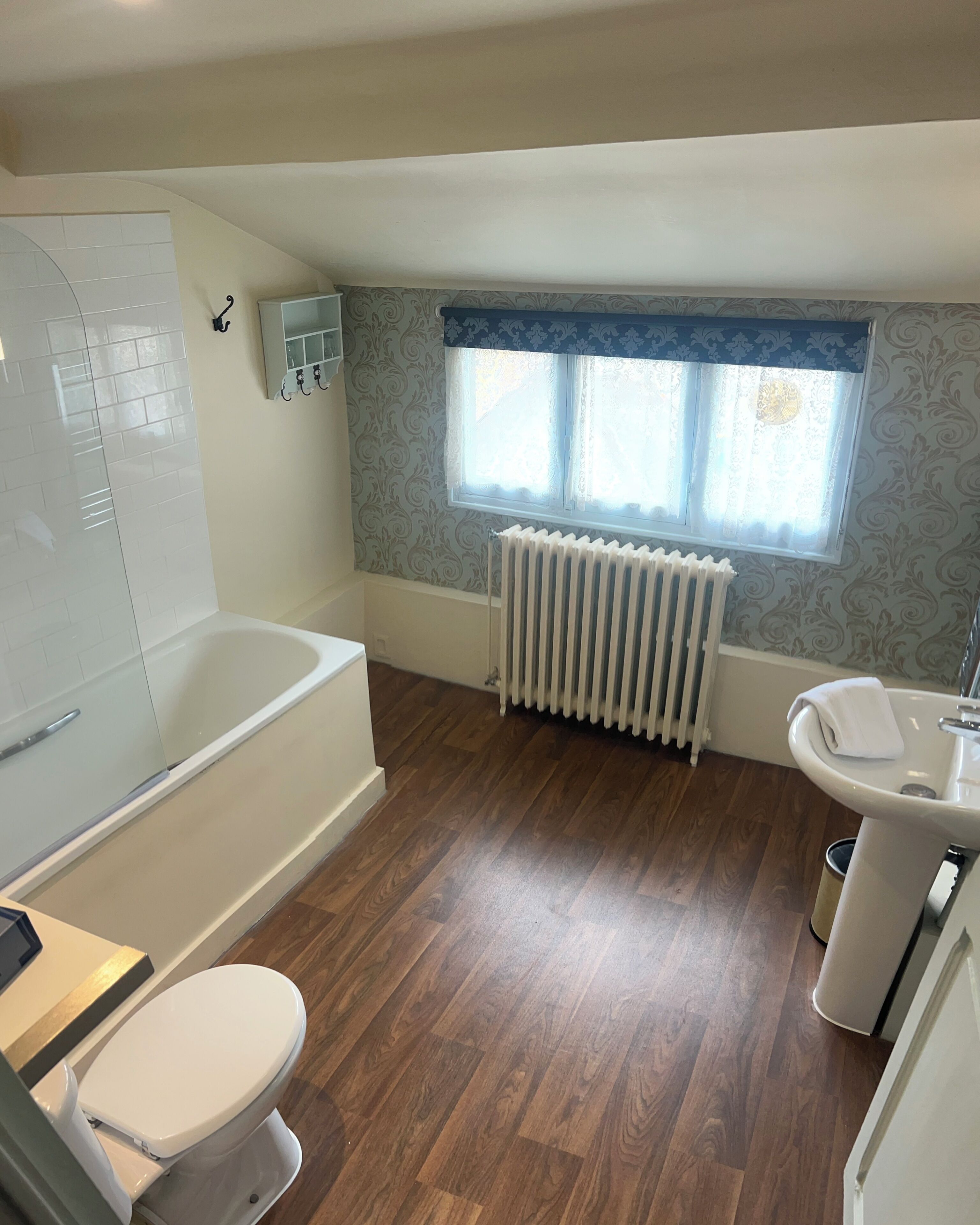 A bathroom with a bathtub, toilet, and sink.