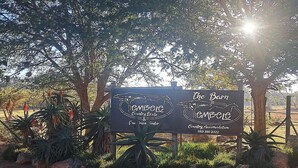 A sign for The Barn Country Estate & Country Accommodation with contact number 083 380 2322.