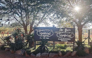 A sign for The Barn Country Estate & Country Accommodation with contact number 083 380 2322.