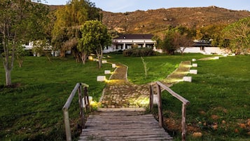 A wooden pathway leading to a building with a stone pathway.