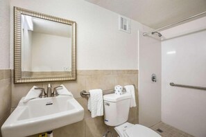 A bathroom with a sink, toilet, and shower. - 2 Full Bed  with kitchenette Non-Smoking (Orlando FL)