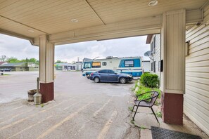 A covered parking area with a blue RV and a car parked. - Pipestone|Queen Bed|Nsmk (Pipestone)