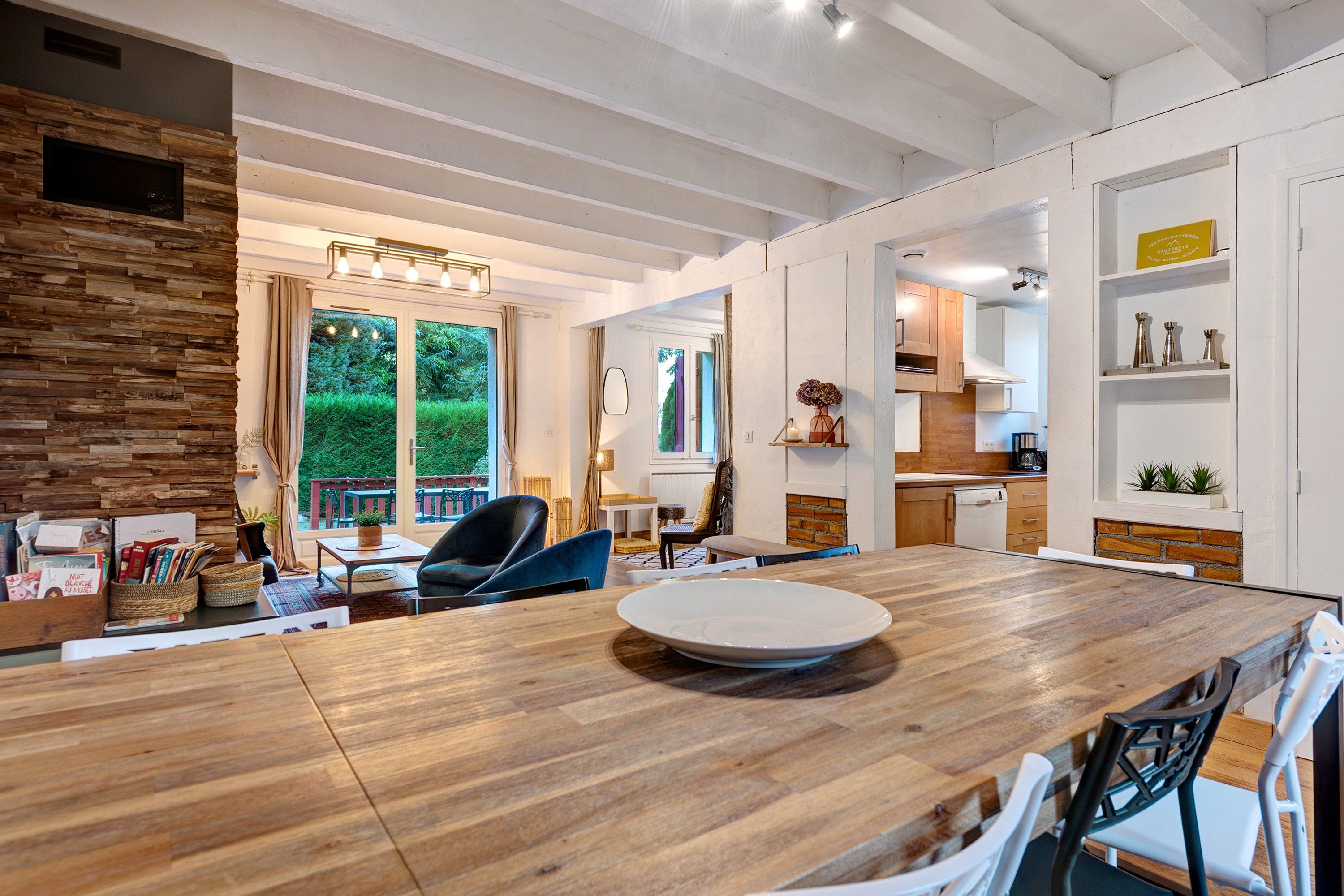 A modern kitchen with white cabinets, a wooden countertop, and a built-in oven.