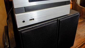 A Kenwood radio on a wooden cabinet.