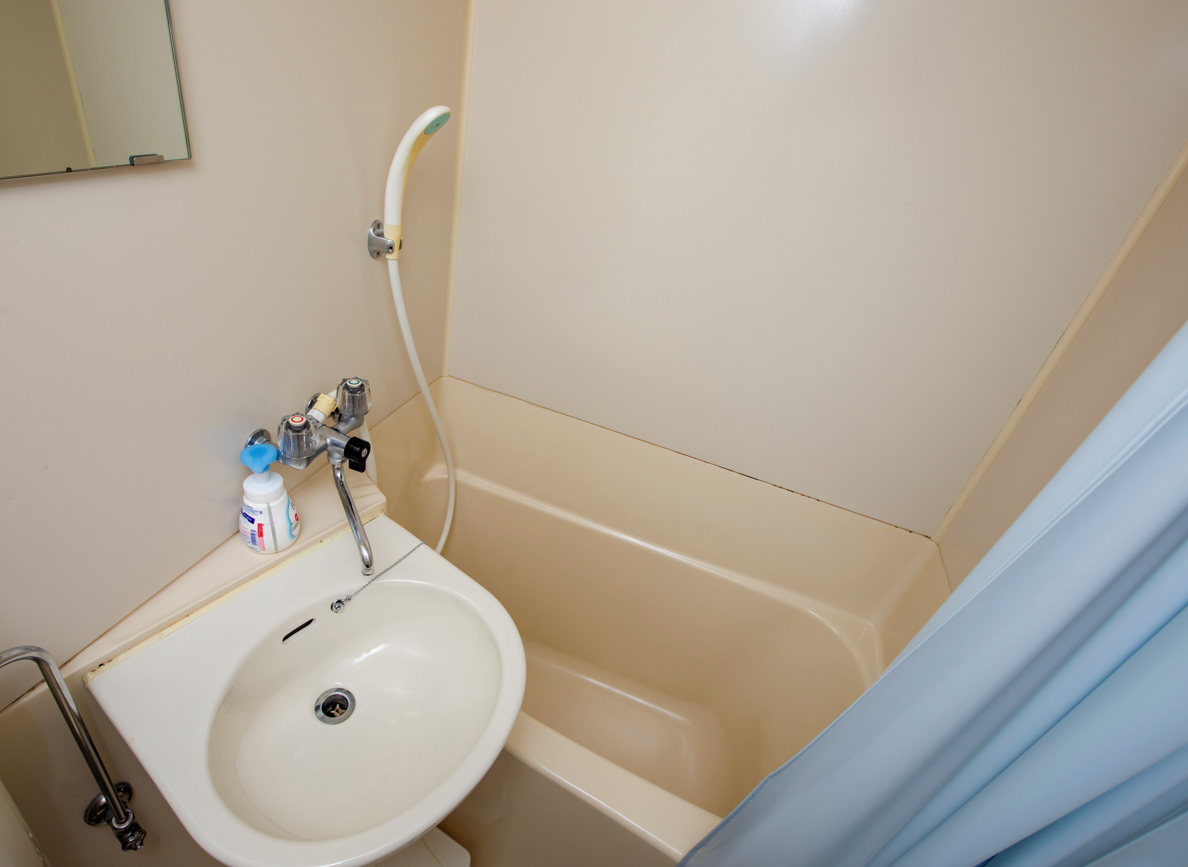 A bathroom with a sink, a bathtub, and a shower.