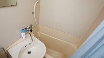 A bathroom with a sink, a bathtub, and a shower.