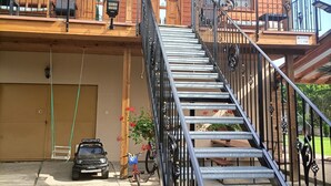 Un edificio de dos pisos con una escalera que lleva a un balcón.