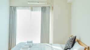A neatly made bed with a grey quilt, white linens, and a wooden headboard. - GrandPacific Ebisuhonmachi (Osaka)