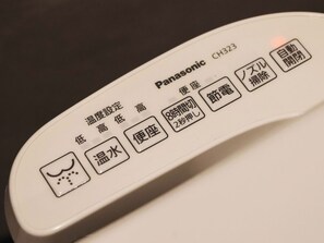 Un control remoto Panasonic CH323 con instrucciones en japonés.