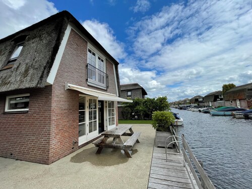 Luxury holiday home for 6 guests featuring a spacious waterfront terrace, a private swimming ladder, and its own mooring dock.