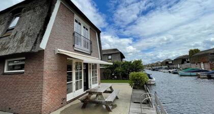 Luxury holiday home for 6 guests featuring a spacious waterfront terrace, a private swimming ladder, and its own mooring dock.