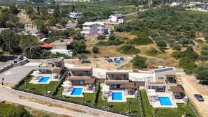 A modern resort with multiple villas, each featuring a private pool and a well-maintained garden. - Orama Sunset | Stela Villa (Rhodes)