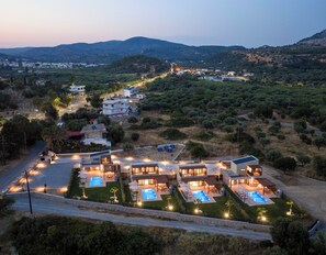 A residential area with multiple houses, a swimming pool, and a road. - Orama Sunset | Joana Villa (Rhodes)